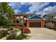 Inviting red brick home with blue accents, boasting professional landscaping and a spacious driveway at 3142 Captains Ln, Longmont, CO 80503