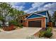 Attractive brick home with a well-maintained lawn, colorful flowerbeds, and an attached two-car garage at 3142 Captains Ln, Longmont, CO 80503