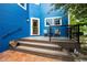 Charming front porch with black railings, a sitting area, stairs and blue siding on the house at 3142 Captains Ln, Longmont, CO 80503