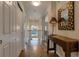 Hallway features hardwood floors, decorative mirror, table with a lamp, access to multiple rooms, and staircase views at 3142 Captains Ln, Longmont, CO 80503