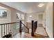 Upstairs hallway with hardwood floors, a decorative runner, multiple windows, and access to several bedrooms at 3142 Captains Ln, Longmont, CO 80503