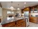 Bright kitchen featuring a center island with granite countertop and custom wood cabinetry with stainless steel appliances at 3142 Captains Ln, Longmont, CO 80503