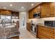 Gourmet kitchen with stainless steel appliances, granite countertops, subway tile backsplash, and ample cabinet space at 3142 Captains Ln, Longmont, CO 80503