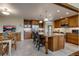 Spacious kitchen featuring a center island with bar seating, stainless steel appliances, and custom wood cabinetry at 3142 Captains Ln, Longmont, CO 80503
