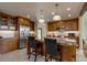 Spacious kitchen featuring a center island with bar seating, stainless steel appliances, and custom wood cabinetry at 3142 Captains Ln, Longmont, CO 80503