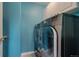 This laundry room features side-by-side washer and dryer units with modern appliances and blue paint at 3142 Captains Ln, Longmont, CO 80503