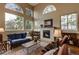 Inviting living room with high ceilings, large windows, a fireplace, and ample seating at 3142 Captains Ln, Longmont, CO 80503