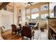 Open living room with a cozy fireplace, hardwood floors, and a soaring ceiling, perfect for entertaining at 3142 Captains Ln, Longmont, CO 80503
