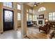 Light-filled living room with a fireplace, tall ceilings, and large windows that provide ample natural light at 3142 Captains Ln, Longmont, CO 80503