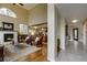 Bright living room featuring a stone fireplace, wood floors, and a smooth transition to the kitchen at 3142 Captains Ln, Longmont, CO 80503