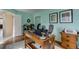 Bright home office featuring natural light, modern desk, comfortable chair, and calming aqua blue walls at 3142 Captains Ln, Longmont, CO 80503
