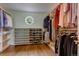 Walk-in closet offers built-in shelves and drawers, hanging rods, and a round window that provides natural light at 3142 Captains Ln, Longmont, CO 80503