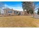 Ranch home with a spacious lawn and mature trees at 2602 S Lafayette St, Denver, CO 80210