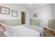 Bright bedroom with a queen bed, wood floors, and ceiling fan at 2602 S Lafayette St, Denver, CO 80210