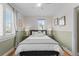 Cozy bedroom with a queen-size bed and window with plantation shutters at 2602 S Lafayette St, Denver, CO 80210