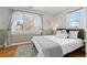 Spacious bedroom featuring a plush bed, window with shutters and wood floors at 2602 S Lafayette St, Denver, CO 80210