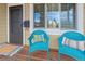 Inviting front porch with blue wicker chairs and a rug at 2602 S Lafayette St, Denver, CO 80210