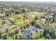 Expansive aerial view showcases the home, fountain, outbuildings, circular driveway, and landscaping at 1075 E Oxford Ln, Cherry Hills Village, CO 80113