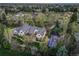 This home features verdant landscaping, a sports court, and a large, well-kept yard at 1075 E Oxford Ln, Cherry Hills Village, CO 80113