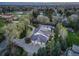 A sprawling estate with mature trees, a long driveway, and a three-car garage is featured at 1075 E Oxford Ln, Cherry Hills Village, CO 80113