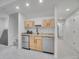 A basement bar area is appointed with granite countertops and light wood cabinetry with stainless appliances at 1075 E Oxford Ln, Cherry Hills Village, CO 80113