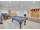Finished basement area includes a pool table and dining set, entertainment center, and wet bar at 1075 E Oxford Ln, Cherry Hills Village, CO 80113