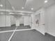 Finished basement features include a wall of mirrors, recessed lighting, and access to other rooms at 1075 E Oxford Ln, Cherry Hills Village, CO 80113