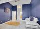 Bedroom with textured blue wallpaper, daybed, and access to ensuite bathroom at 1075 E Oxford Ln, Cherry Hills Village, CO 80113