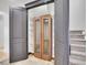 The home features a storage closet with open shelving behind dark gray painted doors and a secondary shelved cabinet at 1075 E Oxford Ln, Cherry Hills Village, CO 80113