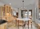 Elegant dining area adjacent to the kitchen with a modern chandelier at 1075 E Oxford Ln, Cherry Hills Village, CO 80113
