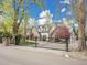 Gated residence featuring a black metal gate and stone pillars at 1075 E Oxford Ln, Cherry Hills Village, CO 80113