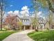 Stunning stone home with a curved driveway and meticulous landscaping at 1075 E Oxford Ln, Cherry Hills Village, CO 80113