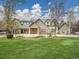 Beautiful stone house with a metal roof and manicured lawn at 1075 E Oxford Ln, Cherry Hills Village, CO 80113