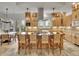 Spacious kitchen features an island with seating, stainless steel hood, pendant lights and plenty of wooden cabinets at 1075 E Oxford Ln, Cherry Hills Village, CO 80113