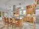Spacious kitchen features an island with seating, stainless steel hood, pendant lights and plenty of wooden cabinets at 1075 E Oxford Ln, Cherry Hills Village, CO 80113