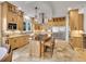 Expansive kitchen with a center island, chef's appliances, and stone floors at 1075 E Oxford Ln, Cherry Hills Village, CO 80113