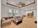 Inviting living room with beamed ceiling, hardwood floors, large windows and an open dining area is ideal for entertaining at 1075 E Oxford Ln, Cherry Hills Village, CO 80113