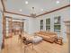 Open concept living room with a fireplace, hardwood floors, beamed ceiling and office access is bathed in light at 1075 E Oxford Ln, Cherry Hills Village, CO 80113