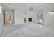 Spacious living room with fireplace, light gray carpet, and french doors to outdoor space at 1075 E Oxford Ln, Cherry Hills Village, CO 80113