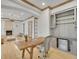 Office has natural lighting, a wood desk, and a beverage fridge at 1075 E Oxford Ln, Cherry Hills Village, CO 80113