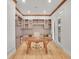 A home office with built-in storage and a wooden desk offers a secluded workspace, enhanced by ample natural light at 1075 E Oxford Ln, Cherry Hills Village, CO 80113