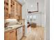 A wet bar is perfectly situated near the living room and includes stone backsplash, cabinet and a wine fridge at 1075 E Oxford Ln, Cherry Hills Village, CO 80113
