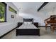 A bright bedroom with black trim windows and a comfortable bed featuring gray and white patterned bedding at 5896 Peregrine Trl, Golden, CO 80403