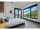 Bright bedroom with a large window view of mountains and nature, creating a serene and peaceful atmosphere at 5896 Peregrine Trl, Golden, CO 80403