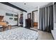 Modern bedroom featuring a large patterned bed, wood dresser, and bathroom through a curtained doorway at 5896 Peregrine Trl, Golden, CO 80403