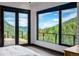 A beautiful view of the mountains and trees from the bedroom window creating a peaceful escape to nature at 5896 Peregrine Trl, Golden, CO 80403