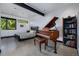 Bright bedroom with a piano, large windows, and a sleek modern design with views of the forest at 5896 Peregrine Trl, Golden, CO 80403