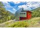 Unique modern home with metal and red accents on a hillside at 5896 Peregrine Trl, Golden, CO 80403