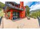 Outdoor living space with a grill, firepit, and patio furniture on the patio of the modern red house at 5896 Peregrine Trl, Golden, CO 80403