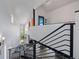 View from above of the main foyer featuring black metal railing and a view to the living room and fireplace at 5896 Peregrine Trl, Golden, CO 80403